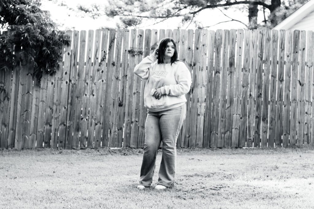 Senior Portrait of a Female against a rustic country setting, shot with a 85mm lens
