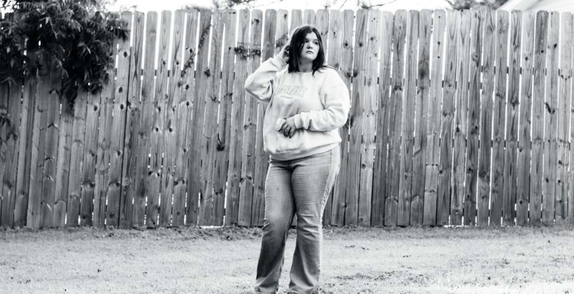 Senior Portrait of a Female against a rustic country setting, shot with a 85mm lens