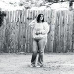 Senior Portrait of a Female against a rustic country setting, shot with a 85mm lens