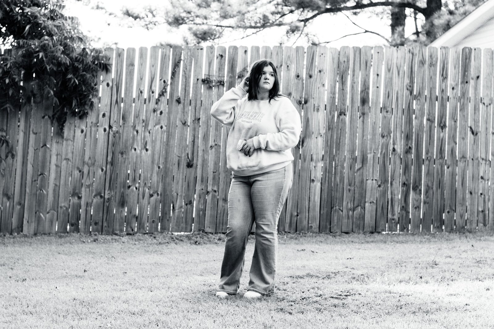 Senior Portrait of a Female against a rustic country setting, shot with a 85mm lens